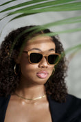 Load image into Gallery viewer, A model wearing stylish zebrawood sunglasses, adding a touch of elegance and sophistication.