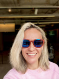 Load image into Gallery viewer, A woman in a pink sweater wearing Purpleheart wood sunglasses.