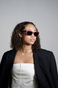 Load image into Gallery viewer, An elegant lady wearing a black blazer and trendy purpleheart wood sunglasses.