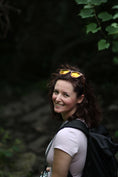 Load image into Gallery viewer, A woman with a backpack, wearing walnut wood sunglasses, explores the great outdoors.