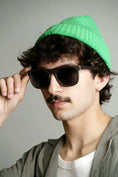 Load image into Gallery viewer, A stylish man with a green hat and trendy wenge wood sunglasses.