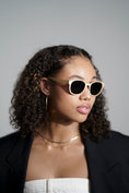 Load image into Gallery viewer,  A woman in a black blazer wearing stylish maple wood sunglasses.