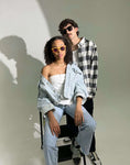 Load image into Gallery viewer, A young couple wearing wooden sunglasses posing confidently for the camera, exuding style and charm.