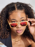 Load image into Gallery viewer, A woman with curly hair wearing wooden sunglasses, exuding style and confidence.
