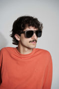 Load image into Gallery viewer, A man in an orange sweater wearing sunglasses made of Wenge wood.
