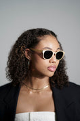 Load image into Gallery viewer,  A woman in a black blazer wearing stylish maple wood sunglasses.
