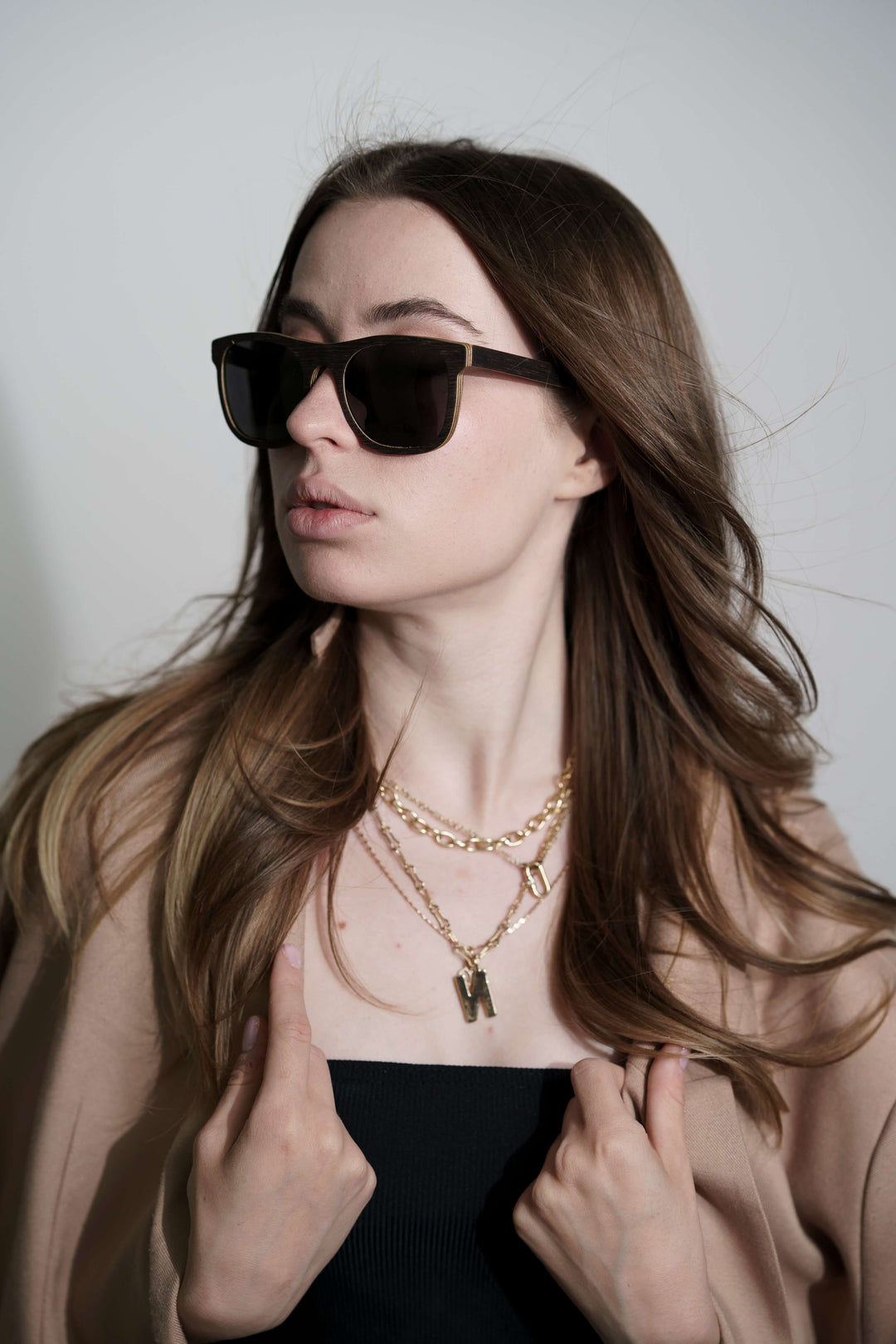 Image of a woman in wooden sunglasses and a necklace.